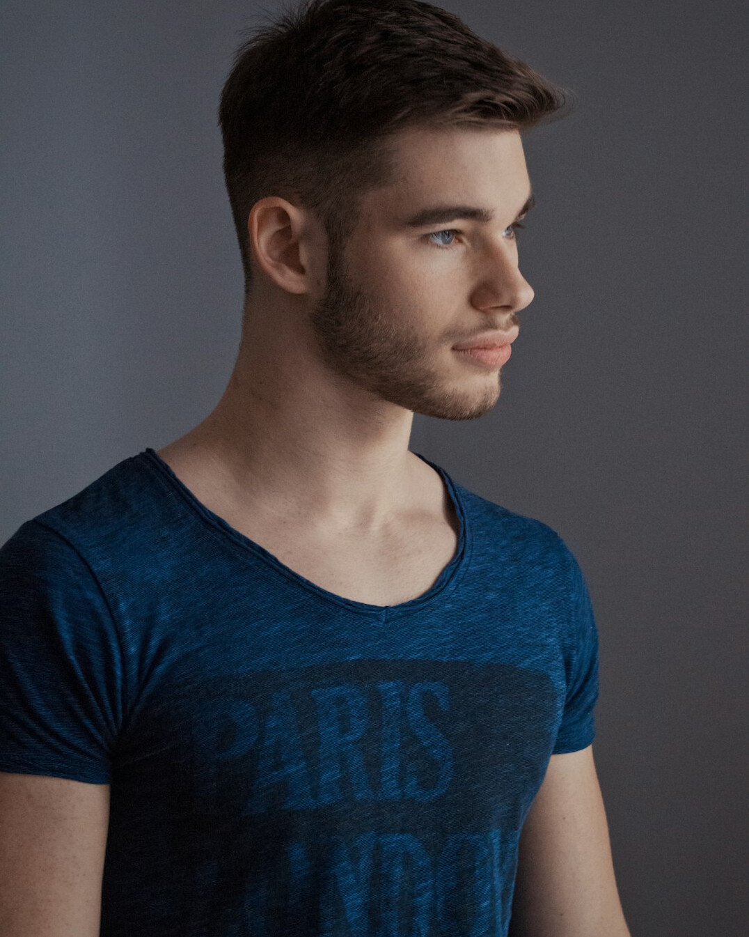 Studio portrait of a smiling young man with short hair