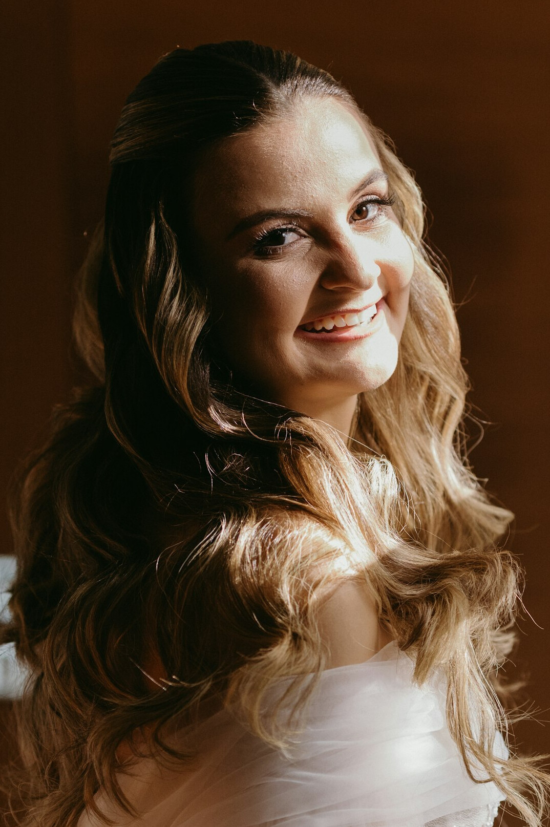 Studio portrait of a smiling woman with long hair