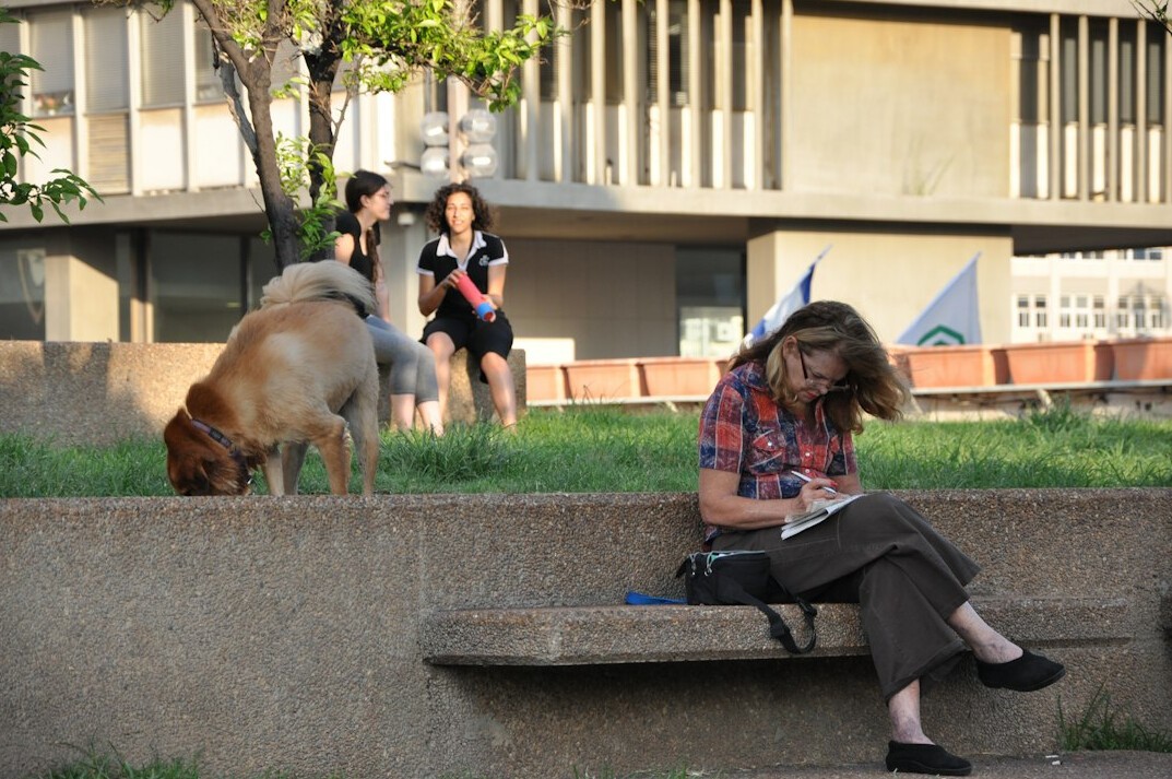 person writing in notebook