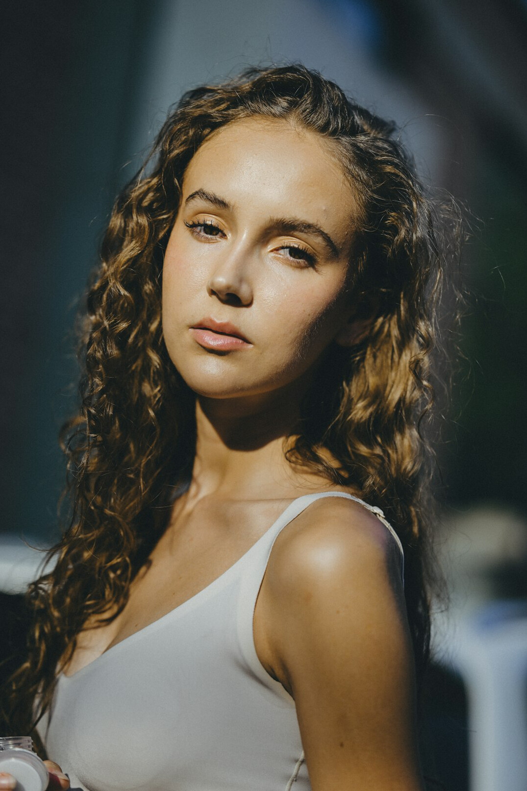 Studio portrait of a young woman with curly hair